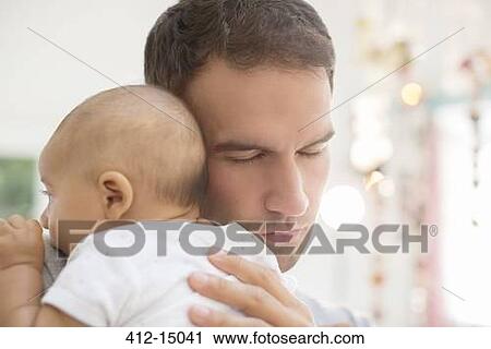 Stock Image - Father holding baby boy. Fotosearch