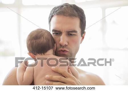 Stock Photo - Father holding baby boy. Fotosearch