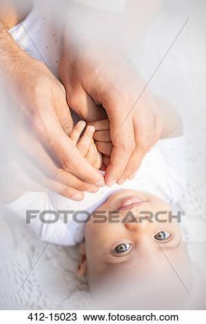 Father holding baby boy's hands View Large Photo Image Stock Image - Father holding baby boy's hands. Fotosearch