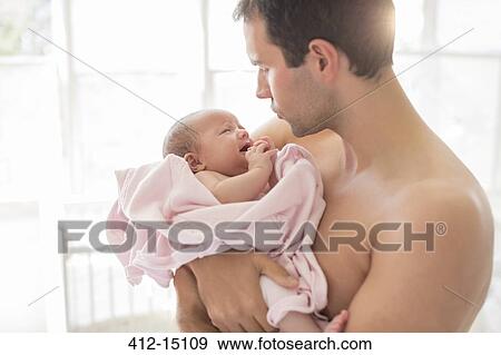 Stock Photo - Father holding crying baby girl. Fotosearch
