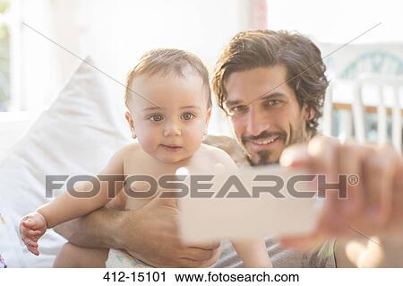 Father taking self-portrait with baby boy View Large Photo Image Stock Image - Father taking self-portrait with baby boy. Fotosearch