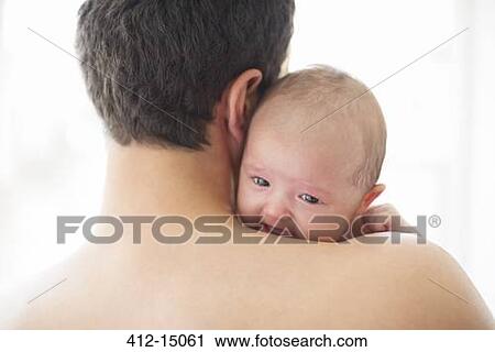 Stock Image - Man comforting crying baby girl. Fotosearch