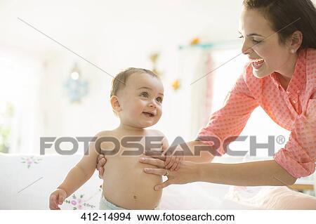Mother helping baby boy walk View Large Photo Image Picture - Mother helping baby boy walk. Fotosearch