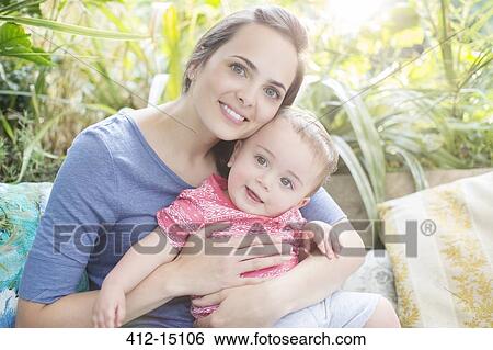 Mother holding baby boy outdoors View Large Photo Image Stock Photograph - Mother holding baby boy outdoors. Fotosearch