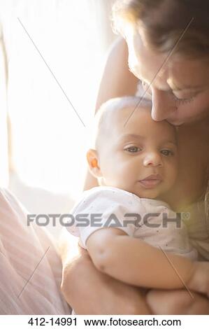 Stock Image - Mother holding baby boy. Fotosearch