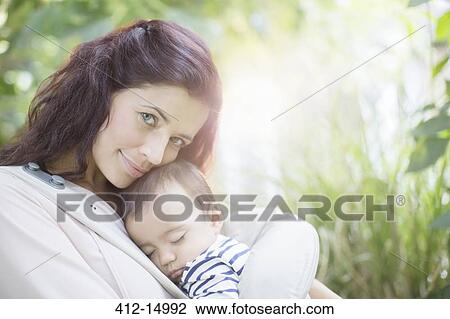 Mother holding baby girl outdoors View Large Photo Image Stock Image - Mother holding baby girl outdoors. Fotosearch