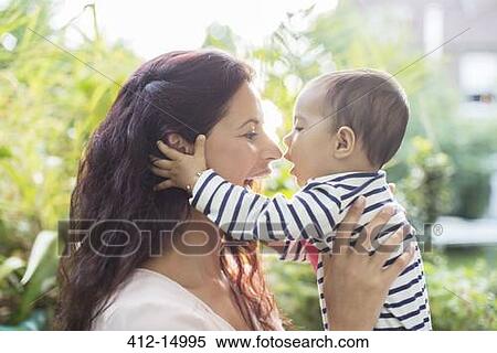 Mother holding baby girl outdoors View Large Photo Image Stock Photography - Mother holding baby girl outdoors. Fotosearch