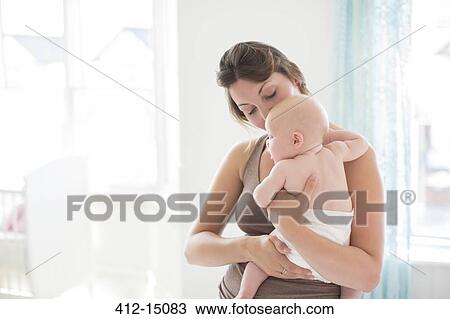 Mother holding baby girl View Large Photo Image Stock Image - Mother holding baby girl. Fotosearch