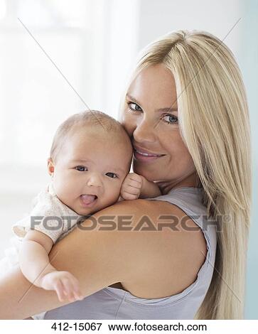 Mother holding baby girl View Large Photo Image Stock Photo - Mother holding baby girl. Fotosearch