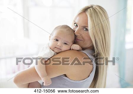 Mother holding baby girl View Large Photo Image Stock Photograph - Mother holding baby girl. Fotosearch