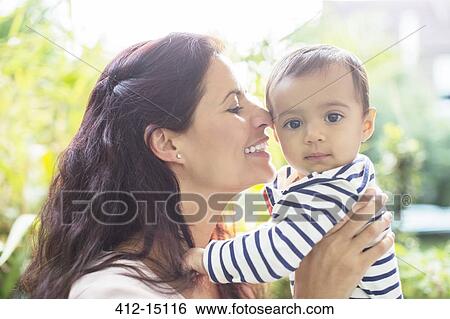 Stock Photograph - Mother holding baby girl. Fotosearch