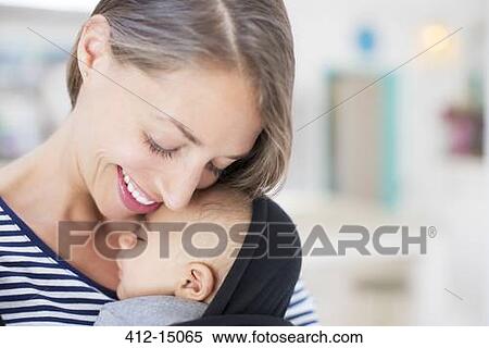 Stock Photography - Mother holding sleeping baby boy. Fotosearch