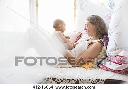 Picture - Mother playing with baby boy. Fotosearch