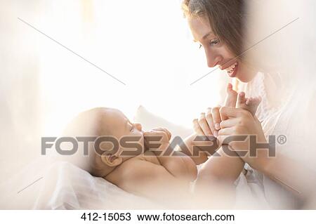 Mother playing with baby boy View Large Photo Image Stock Image - Mother playing with baby boy. Fotosearch