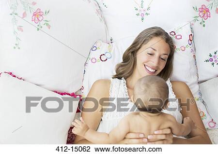 Stock Image - Mother playing with baby boy. Fotosearch