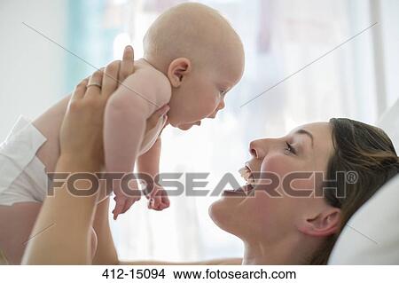 Picture - Mother playing with baby girl. Fotosearch