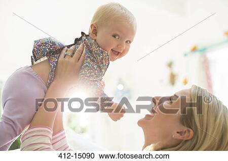 Mother playing with baby girl View Large Photo Image Stock Image - Mother playing with baby girl. Fotosearch
