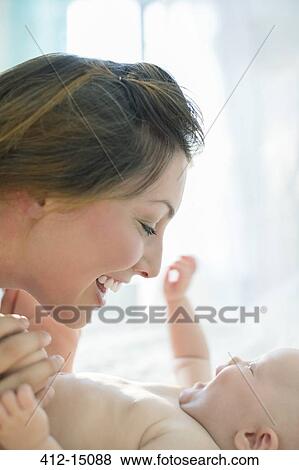 Mother playing with baby girl View Large Photo Image Stock Photo - Mother playing with baby girl. Fotosearch