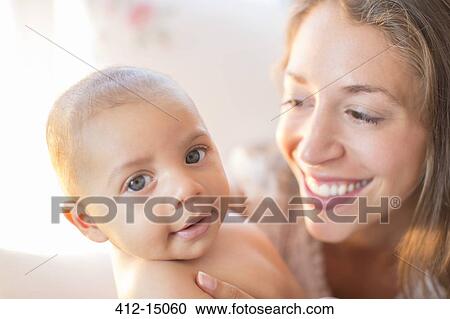 Stock Image - Mother smiling at baby boy. Fotosearch