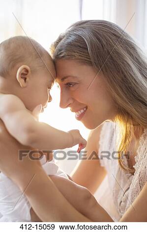Mother touching foreheads with baby boy View Large Photo Image Stock Photo - Mother touching foreheads with baby boy. Fotosearch