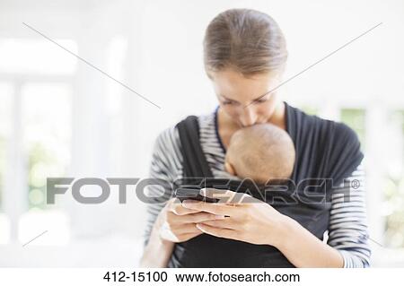 Mother with baby boy using cell phone View Large Photo Image Stock Image - Mother with baby boy using cell phone. Fotosearch