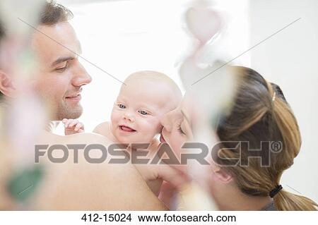 Parents kissing baby girl's cheeks View Large Photo Image Picture - Parents kissing baby girl's cheeks. Fotosearch