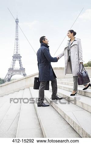 Business people shaking hands by Eiffel Tower, Paris, France View Large Photo Image Stock Image - Business people shaking hands by Eiffel Tower, Paris, France. Fotosearch