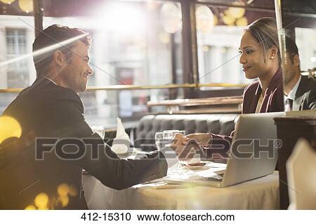 Business people shaking hands in restaurant View Large Photo Image Stock Image - Business people shaking hands in restaurant. Fotosearch