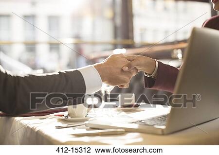 Business people shaking hands in restaurant View Large Photo Image Stock Image - Business people shaking hands in restaurant. Fotosearch