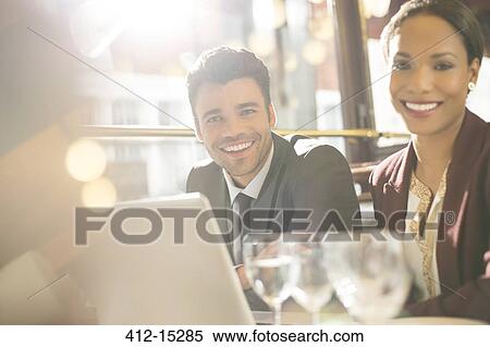 Stock Photography - Business people smiling in restaurant. Fotosearch