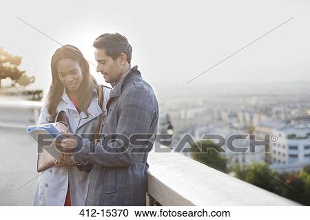 Business people talking at ledge overlooking Paris, France View Large Photo Image Stock Image - Business people talking at ledge overlooking Paris, France. Fotosearch