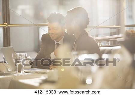 Stock Photo - Business people talking in restaurant. Fotosearch