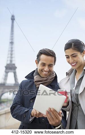 Business people using digital tablet near Eiffel Tower, Paris, France View Large Photo Image Stock Image - Business people using digital tablet near Eiffel Tower, Paris, France. Fotosearch