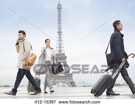Stock Photo - Business people walking near Eiffel Tower, Paris, France. Fotosearch
