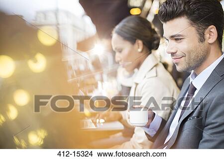 Picture - Business people working at sidewalk cafe. Fotosearch