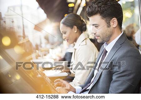 Business people working at sidewalk cafe View Large Photo Image Stock Photo - Business people working at sidewalk cafe. Fotosearch