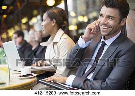 Stock Photo - Business people working at sidewalk cafe. Fotosearch