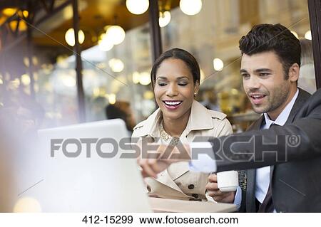 Stock Photo - Business people working at sidewalk cafe. Fotosearch