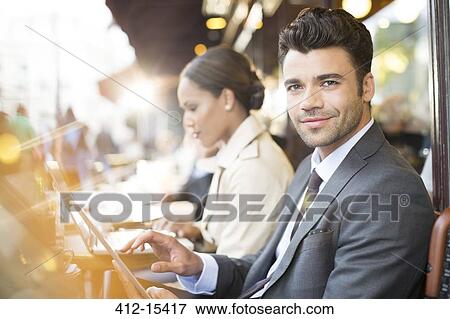 Business people working at sidewalk cafe View Large Photo Image Stock Photo - Business people working at sidewalk cafe. Fotosearch