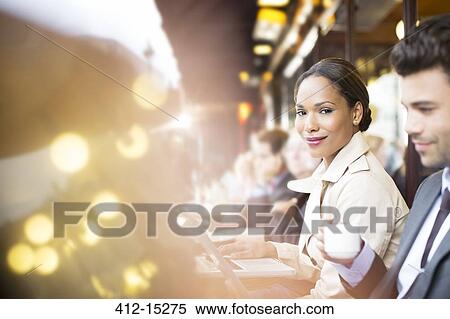 Business people working at sidewalk cafe View Large Photo Image Stock Photography - Business people working at sidewalk cafe. Fotosearch