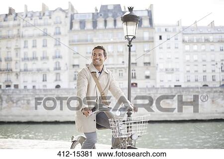 Businessman on bicycle along Seine River, Paris, France View Large Photo Image Stock Image - Businessman on bicycle along Seine River, Paris, France. Fotosearch