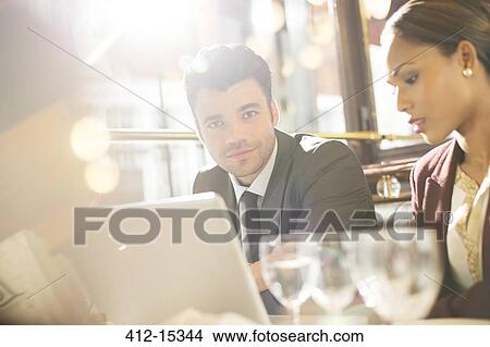 Businessman smiling in restaurant View Large Photo Image Picture - Businessman smiling in restaurant. Fotosearch