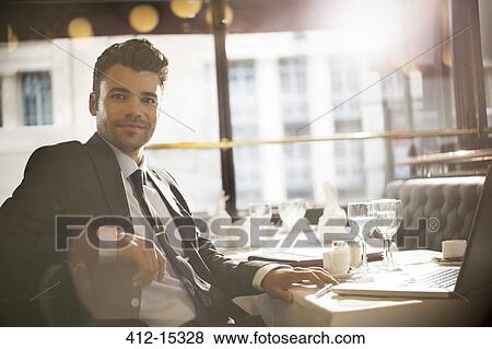 Stock Photo - Businessman smiling in restaurant. Fotosearch