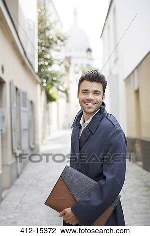 Businessman smiling on street with Sacre Coeur Basilica in background, Paris, France View Large Photo Image Stock Image - Businessman smiling on street with Sacre Coeur Basilica in background, Paris, France. Fotosearch