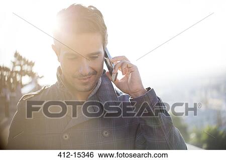 Businessman talking on cell phone View Large Photo Image Stock Photograph - Businessman talking on cell phone. Fotosearch