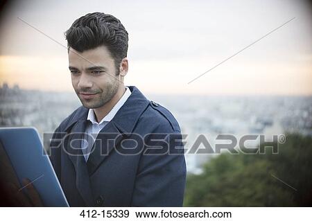 Businessman using digital tablet outdoors View Large Photo Image Stock Photo - Businessman using digital tablet outdoors. Fotosearch