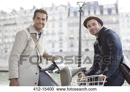 Businessmen on bicycles along Seine River, Paris, France View Large Photo Image Stock Image - Businessmen on bicycles along Seine River, Paris, France. Fotosearch