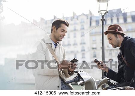Stock Photograph - Businessmen using cell phones. Fotosearch