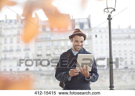 Businessmen using digital tablet along Seine River, Paris, France View Large Photo Image Stock Photography - Businessmen using digital tablet along Seine River, Paris, France. Fotosearch