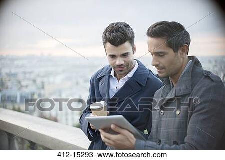 Businessmen using digital tablet with Paris, France in background View Large Photo Image Stock Image - Businessmen using digital tablet with Paris, France in background. Fotosearch
